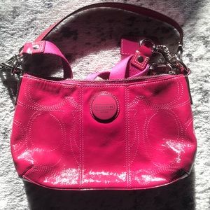 Hot pink Coach crossbody purse in patent leather.
